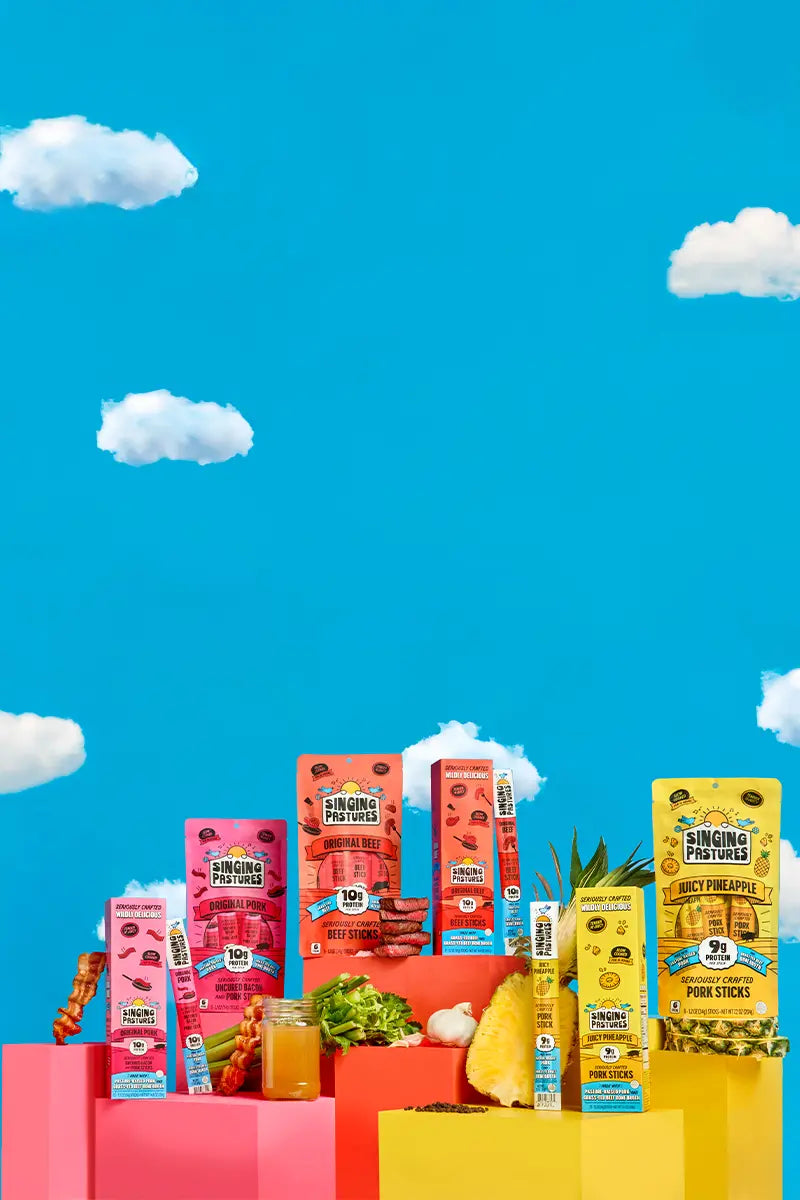 Assorted Singing Pastures products on a colorful platform with a blue sky background